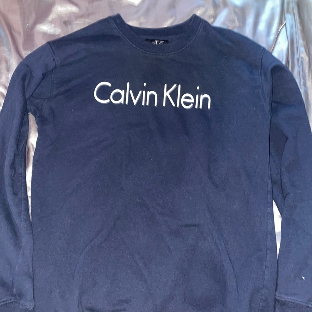 A plain black Calvin Klein long sleeve crew neck.